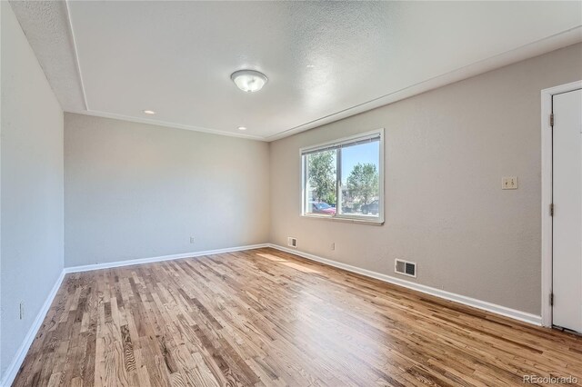 spare room with light hardwood / wood-style flooring