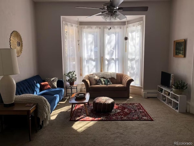 living room featuring ceiling fan, a baseboard radiator, and carpet flooring