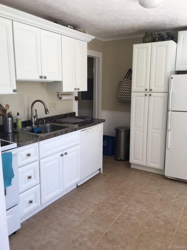 kitchen with white cabinets, white appliances, and sink