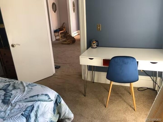 bedroom with dark carpet and a baseboard radiator