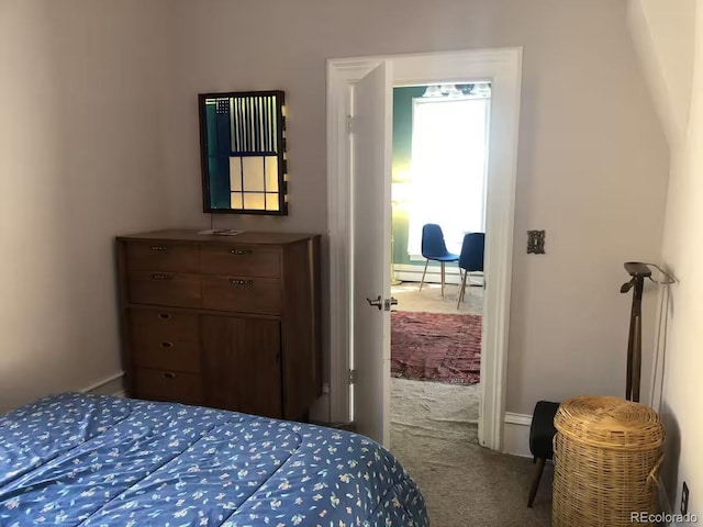 carpeted bedroom featuring baseboard heating