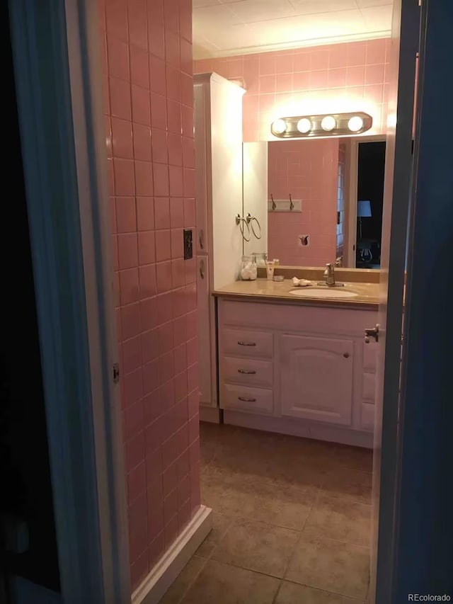 bathroom featuring tile walls, vanity, and tile patterned flooring