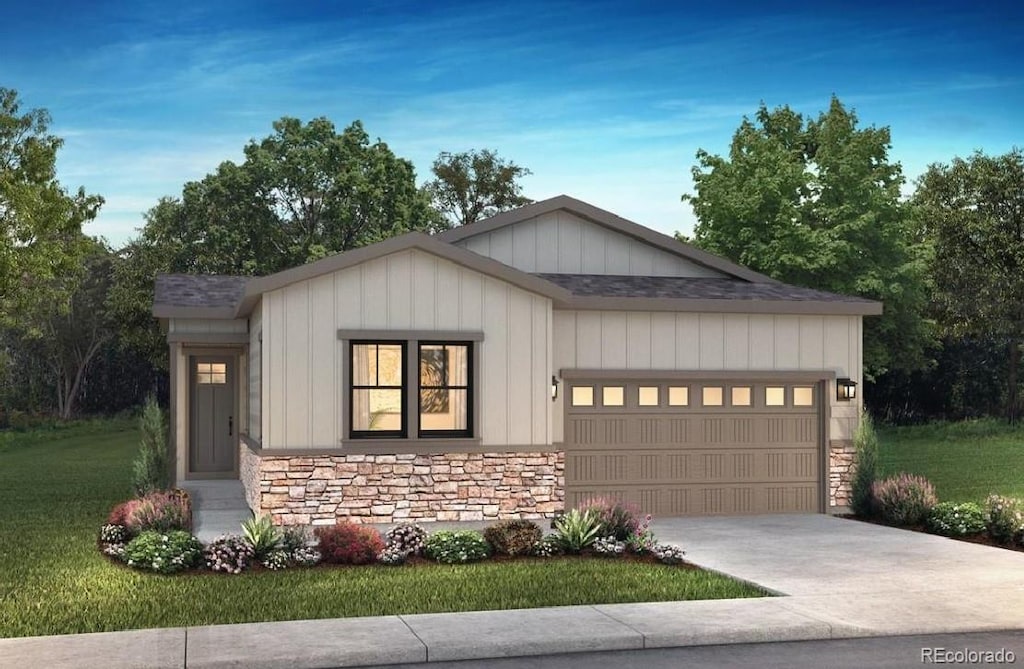 view of front of home with a garage and a front yard