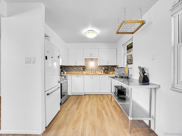5225 Beech St, Arvada, CO 80002 - kitchen with white appliances, light countertops, light wood-style floors, backsplash, and white cabinets