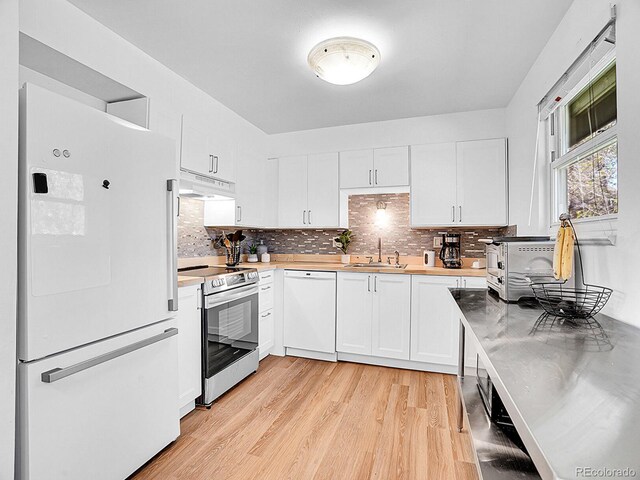 5225 Beech St, Arvada, CO 80002 - kitchen with white appliances, under cabinet range hood, light wood finished floors, white cabinets, and a sink