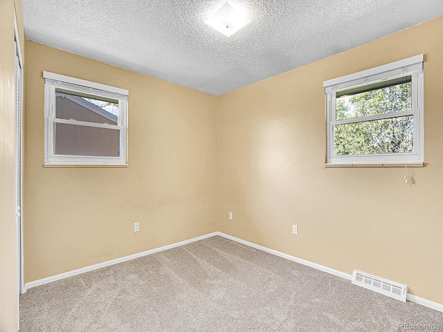 5225 Beech St, Arvada, CO 80002 - empty room with a textured ceiling, carpet, and baseboards