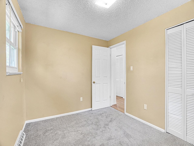5225 Beech St, Arvada, CO 80002 - unfurnished bedroom with baseboards, a closet, carpet, and a textured ceiling