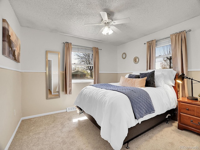 5225 Beech St, Arvada, CO 80002 - bedroom featuring a textured ceiling, light carpet, and ceiling fan