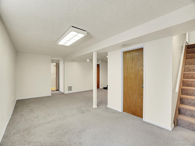 5225 Beech St, Arvada, CO 80002 - finished basement featuring stairs, carpet flooring, a textured ceiling, and baseboards