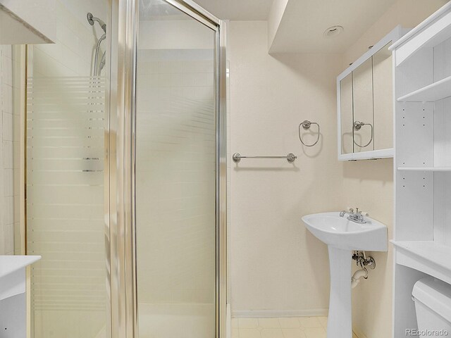 5225 Beech St, Arvada, CO 80002 - bathroom featuring a shower stall, toilet, and baseboards