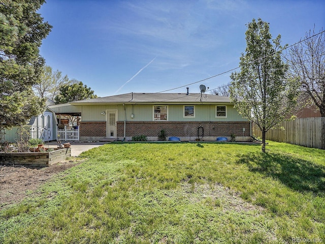 5225 Beech St, Arvada, CO 80002 - rear view of property with brick siding and a vegetable garden