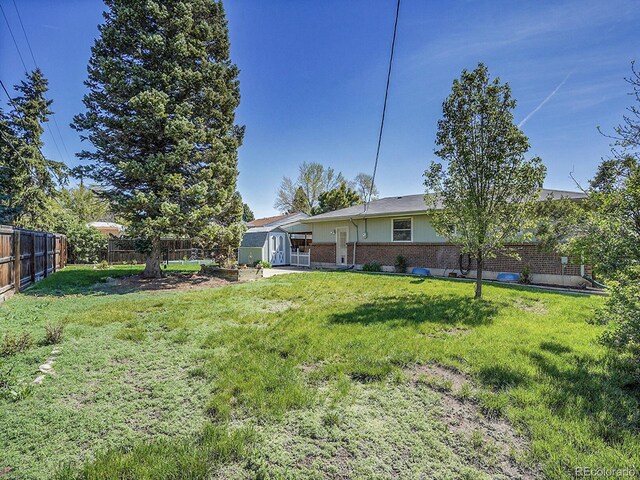 5225 Beech St, Arvada, CO 80002 - view of yard with a storage unit and an outbuilding