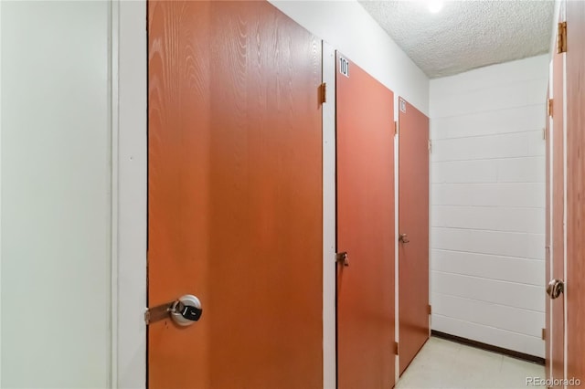hall with a textured ceiling