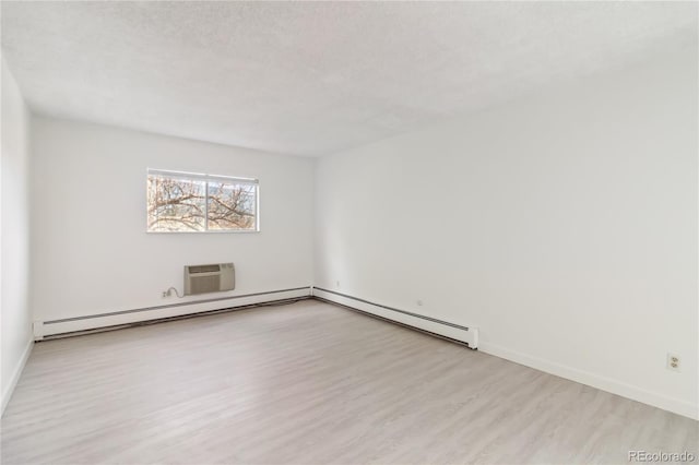 empty room with an AC wall unit, baseboards, a baseboard heating unit, and wood finished floors