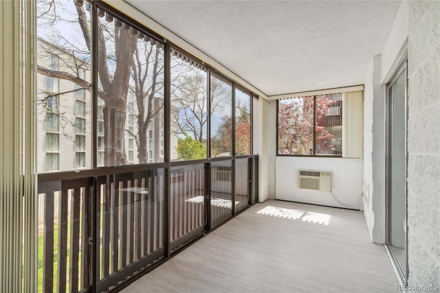 unfurnished sunroom with a wall mounted AC