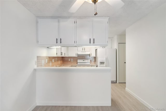 kitchen with white appliances, backsplash, under cabinet range hood, and light wood finished floors