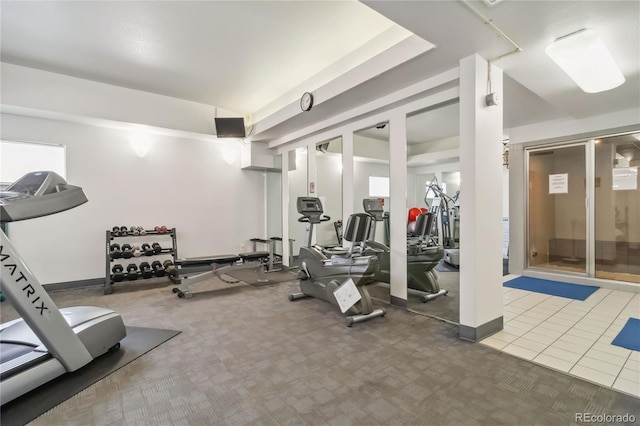 exercise room with tile patterned floors, baseboards, and carpet