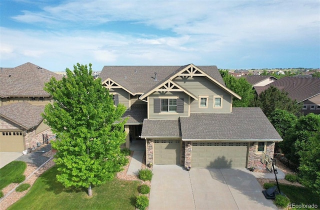 craftsman-style home featuring a front yard and a garage