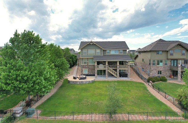 back of property with a wooden deck and a lawn