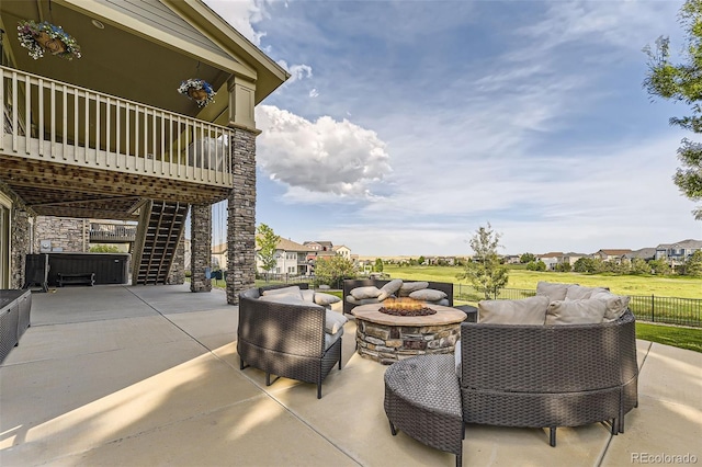 view of patio featuring an outdoor living space with a fire pit