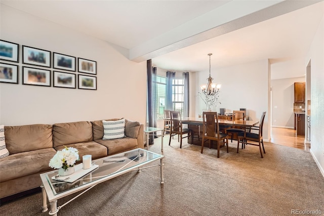 living room with beam ceiling, light colored carpet, and a notable chandelier