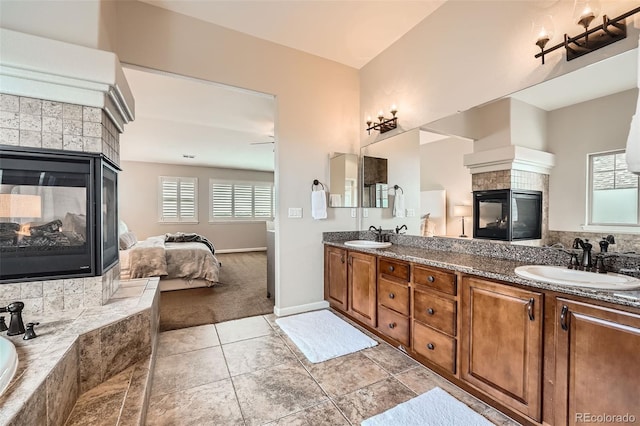 bathroom featuring a fireplace, vanity, and tile patterned flooring