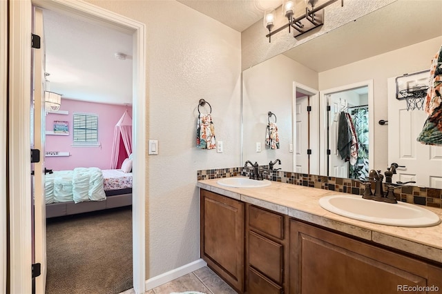 bathroom featuring decorative backsplash and vanity