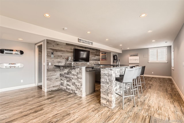 bar with light hardwood / wood-style floors