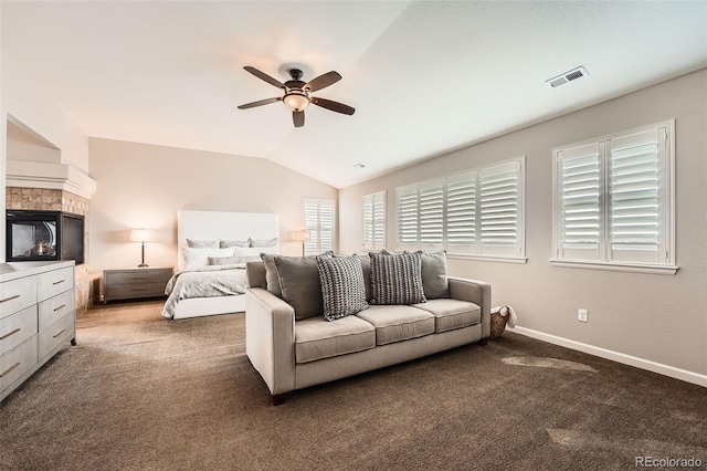 bedroom with dark colored carpet, ceiling fan, lofted ceiling, and multiple windows