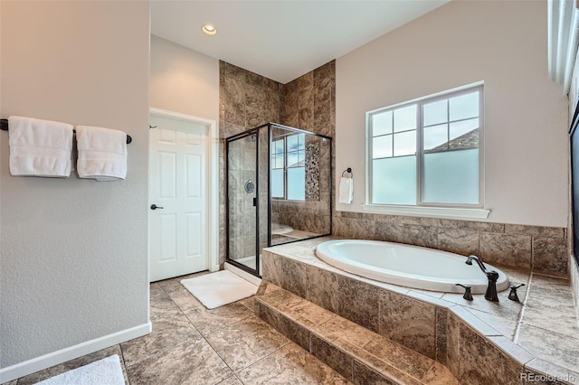 bathroom featuring shower with separate bathtub