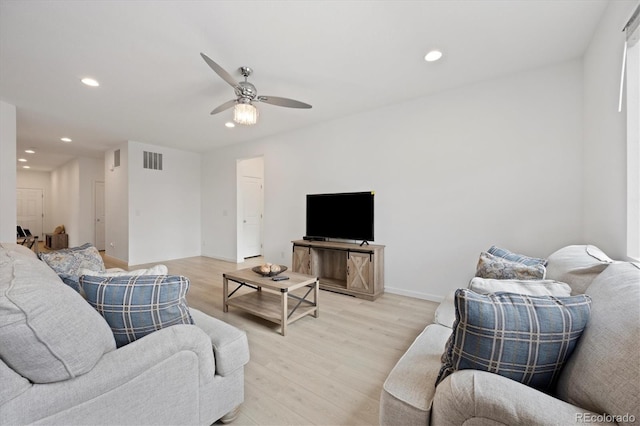 living room featuring ceiling fan and light hardwood / wood-style floors