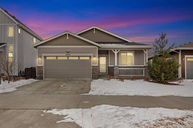 view of front of property featuring a porch and a garage