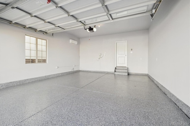 garage with a wall unit AC and a garage door opener