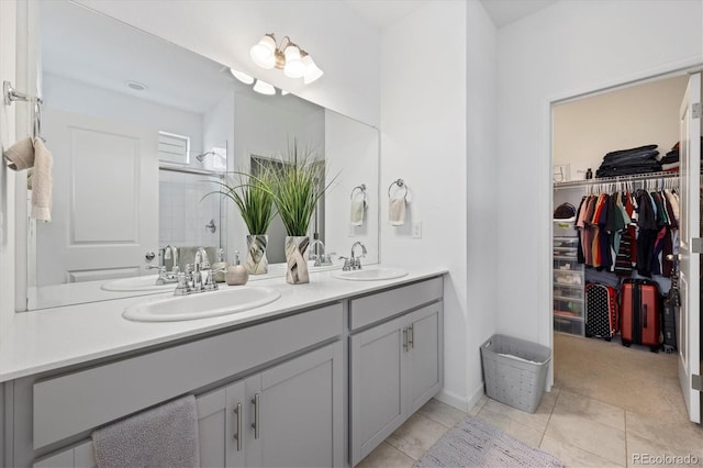 bathroom with vanity, tile patterned floors, and a shower with shower door