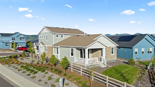 view of front of home featuring a residential view and fence