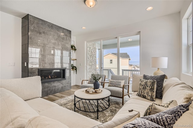 living room featuring wood finished floors, recessed lighting, and a fireplace