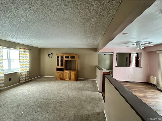 spare room featuring a textured ceiling and ceiling fan