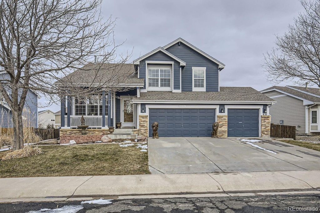 view of front of home with a garage and a front lawn