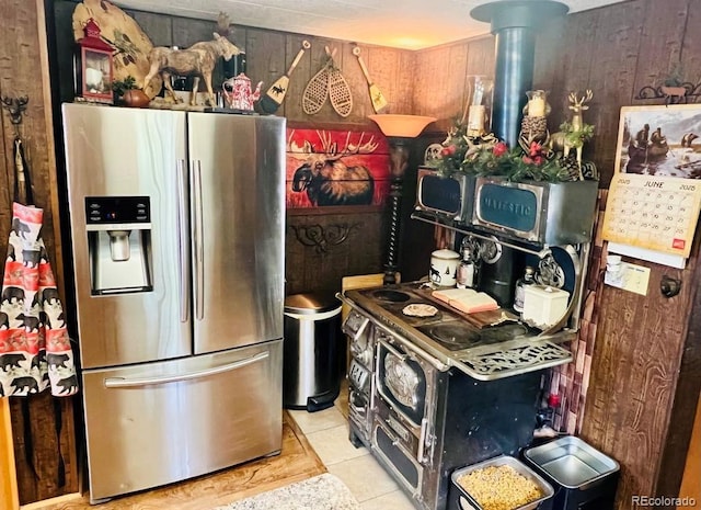 22585 County Road 292, Nathrop, CO 81236 - kitchen with stainless steel fridge, light tile patterned flooring, and wood walls