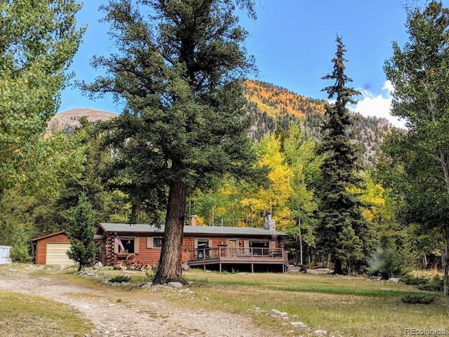 22585 County Road 292, Nathrop, CO 81236 - log home with a deck with mountain view, an outdoor structure, driveway, a forest view, and a garage