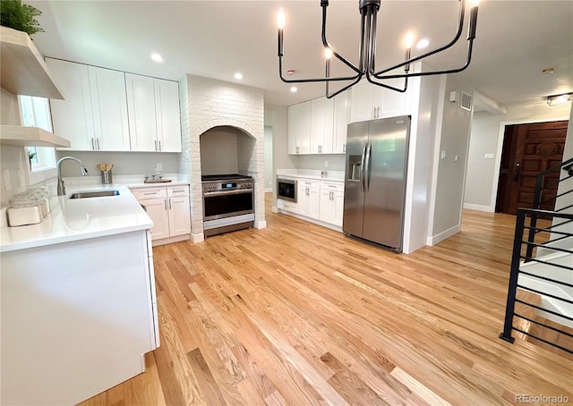 7160 E Iliff Ave, Denver, CO 80224 - kitchen featuring stainless steel appliances, light wood-style floors, white cabinetry, light countertops, and recessed lighting