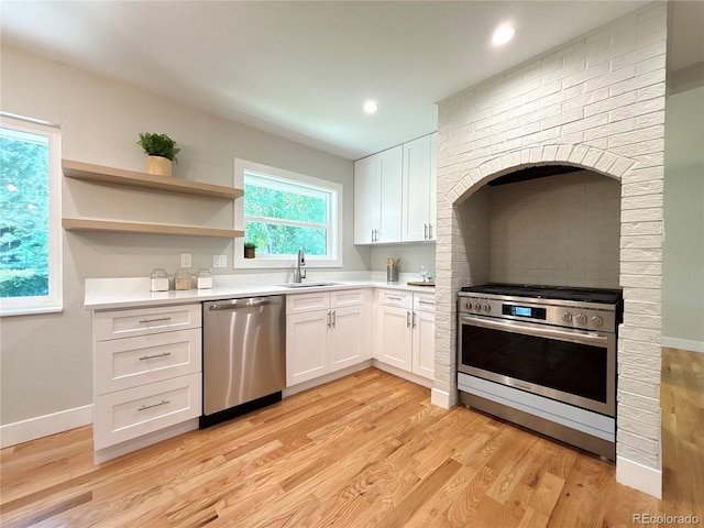7160 E Iliff Ave, Denver, CO 80224 - kitchen with stainless steel appliances, light wood-style flooring, white cabinetry, light countertops, and open shelves