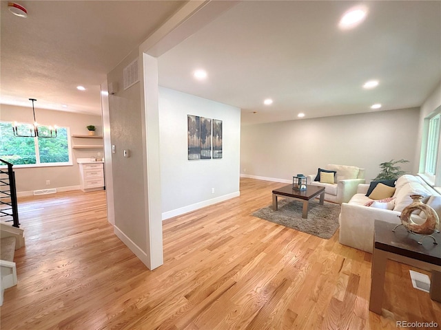 7160 E Iliff Ave, Denver, CO 80224 - living room featuring recessed lighting, a chandelier, and light wood-style floors