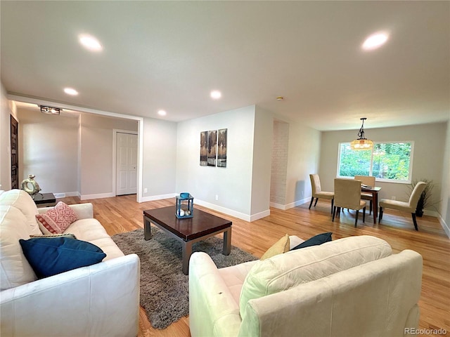 7160 E Iliff Ave, Denver, CO 80224 - living area featuring light wood-style flooring and recessed lighting