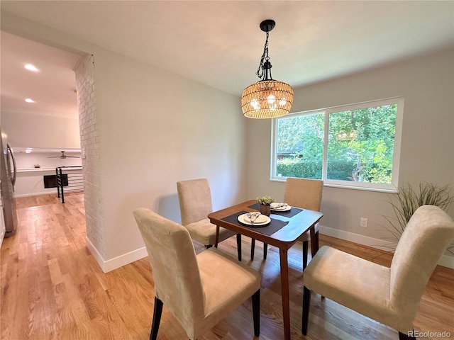 7160 E Iliff Ave, Denver, CO 80224 - dining area featuring light wood-type flooring, a chandelier, and recessed lighting