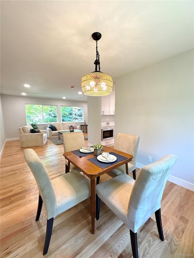7160 E Iliff Ave, Denver, CO 80224 - dining space with a chandelier, light wood finished floors, and recessed lighting