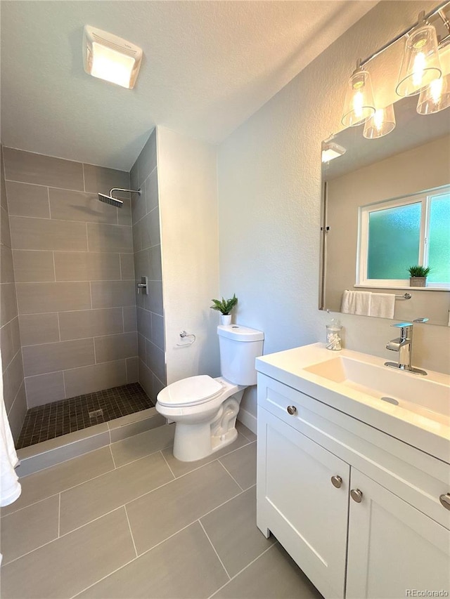 7160 E Iliff Ave, Denver, CO 80224 - full bathroom with vanity, tiled shower, tile patterned floors, a textured wall, and a textured ceiling