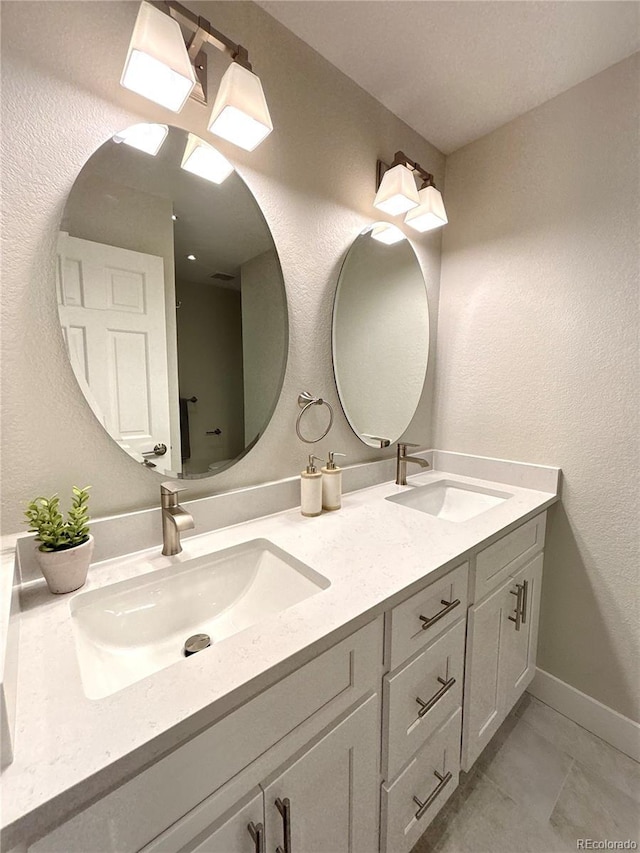 7160 E Iliff Ave, Denver, CO 80224 - bathroom featuring double vanity and baseboards