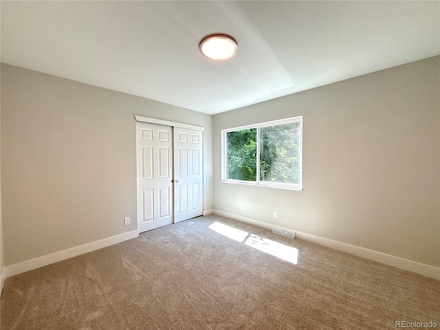 7160 E Iliff Ave, Denver, CO 80224 - unfurnished bedroom with carpet flooring and a closet