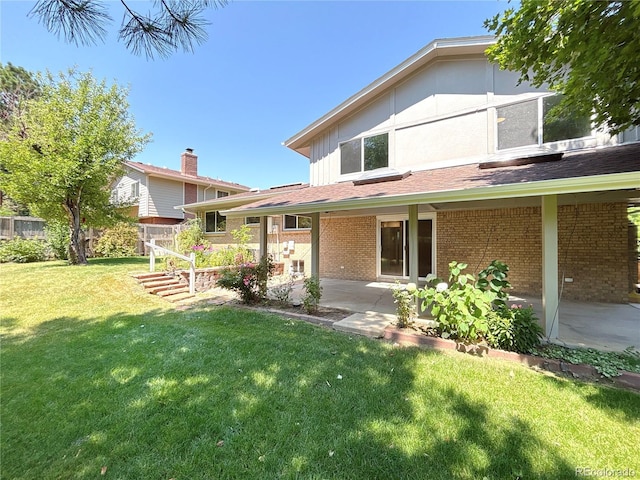7160 E Iliff Ave, Denver, CO 80224 - back of house featuring brick siding and a patio area